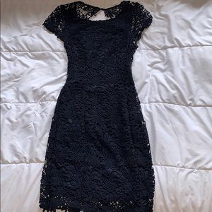 Navy blue lace open-back mini dress.